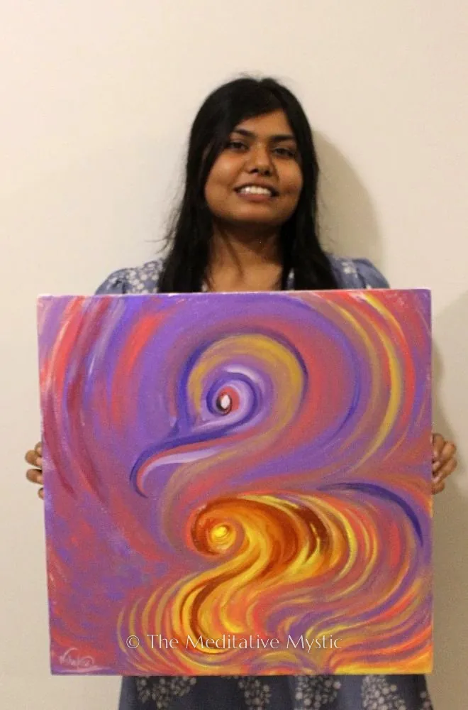 Vishakha holding one of her abstract canvases in violet and gold